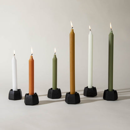 Five Northern Lights Caramel 12&quot; Taper Candles are lined up in a row on a white surface.