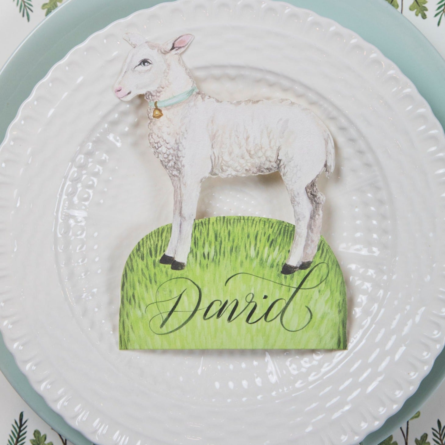 A plate with a Little Lamb place card on it, inspired by the Easter Garden Story, designed by Hester &amp; Cook.