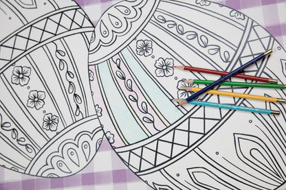 Close-up of the Die-cut Coloring Easter Egg Placemat on an Easter-themed table setting, partially filled in with colored pencils.
