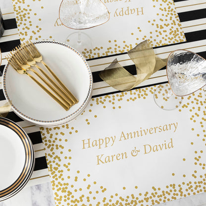 Table setting with Gold Confetti Placemat with personalized message printed in gold color: &quot;Happy Anniversary Karen &amp; David&quot;.
