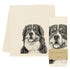A screen-printed Bernese Mountain Dog Tea Towel by Eric & Christopher next to its packaging, made in the USA.