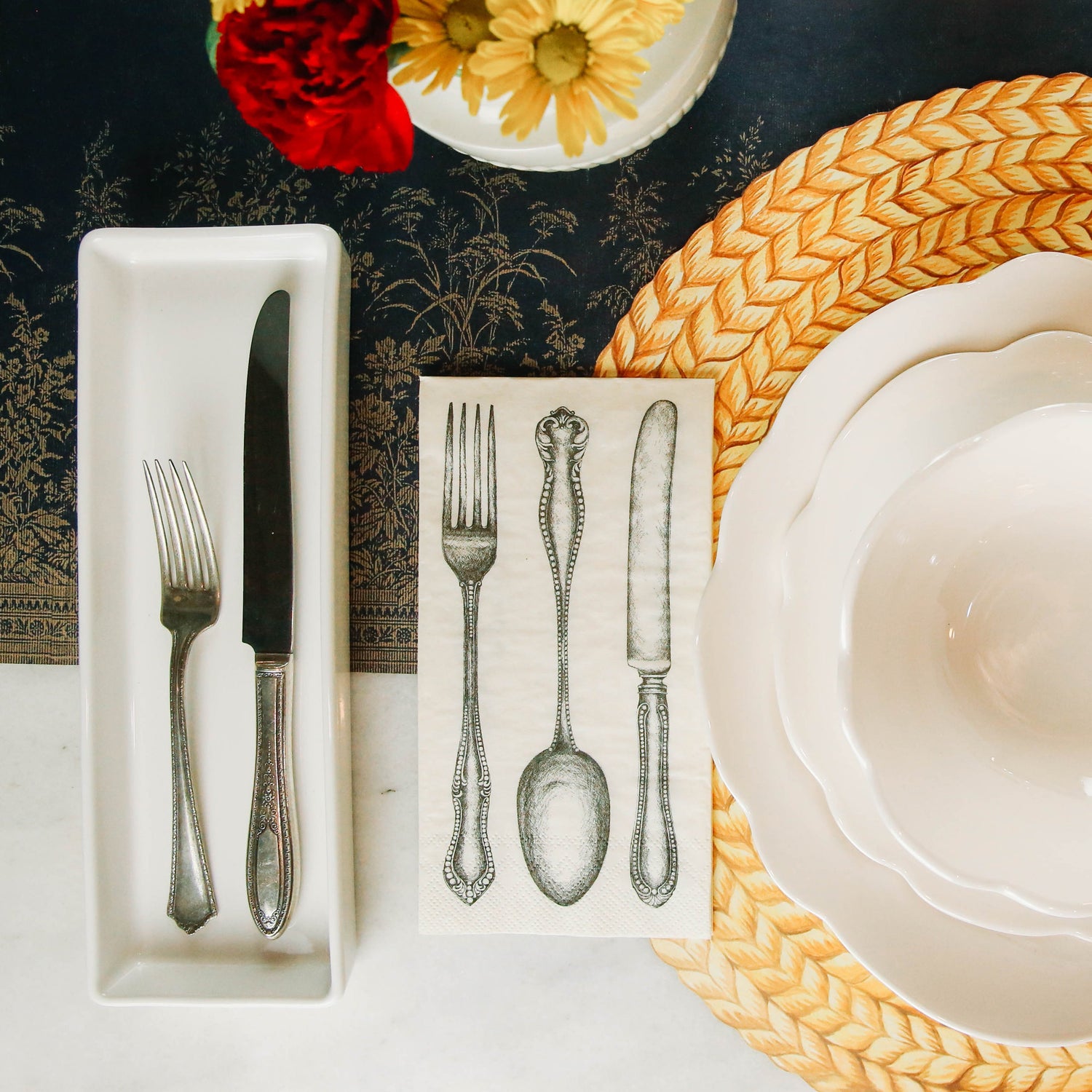 A classic table setting with a knife, fork, and spoon for a party using Classic Cutlery Napkins from Hester &amp; Cook.