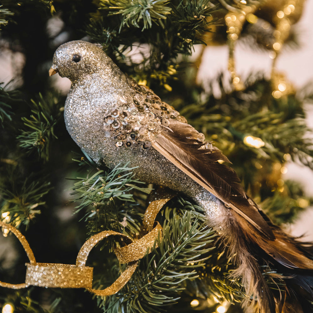 silver glittered feather bird ornament in tree