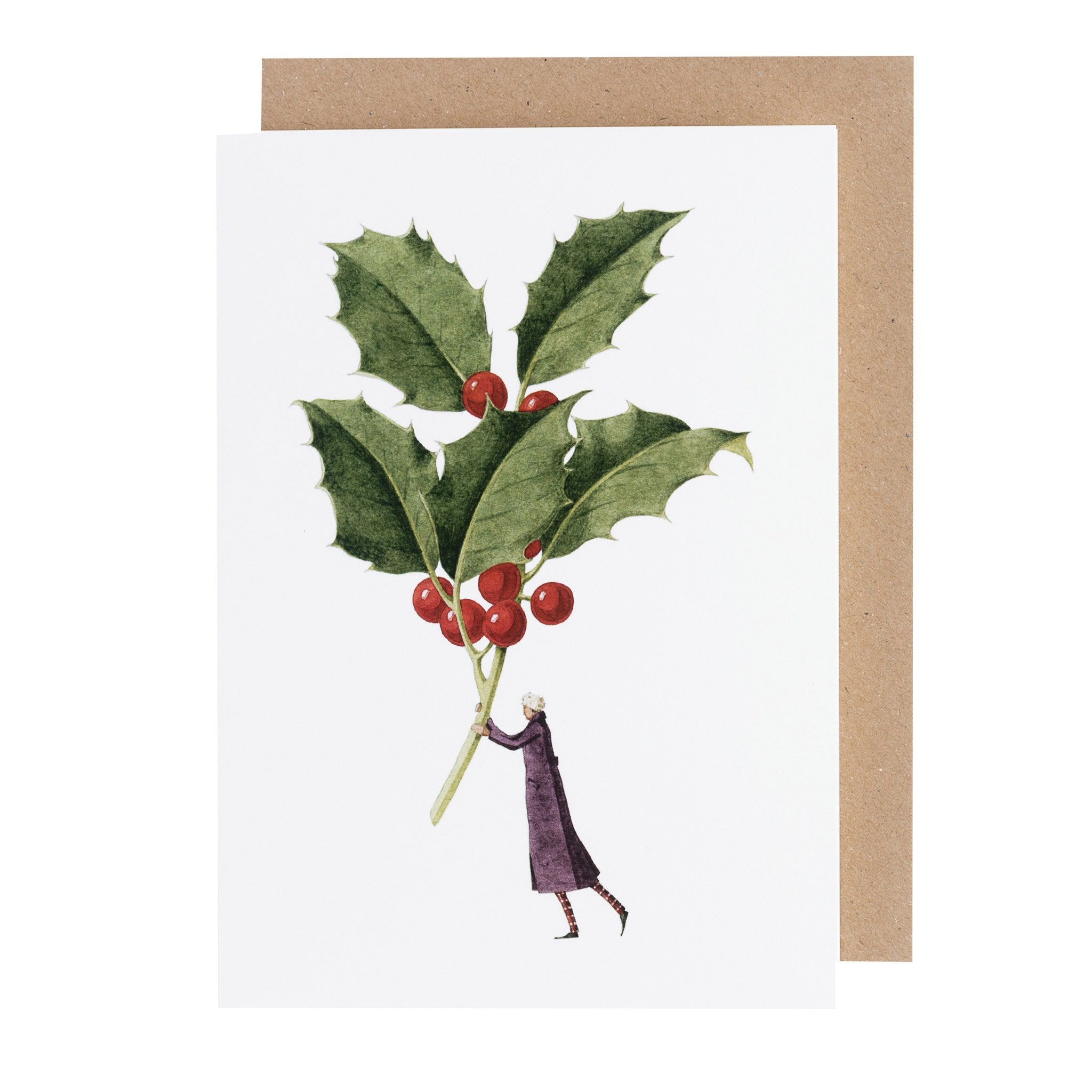 A white greeting card featuring a stylized illustration of a person holding a gigantic sprig of green holly with red berries, with the included raft paper envelope.