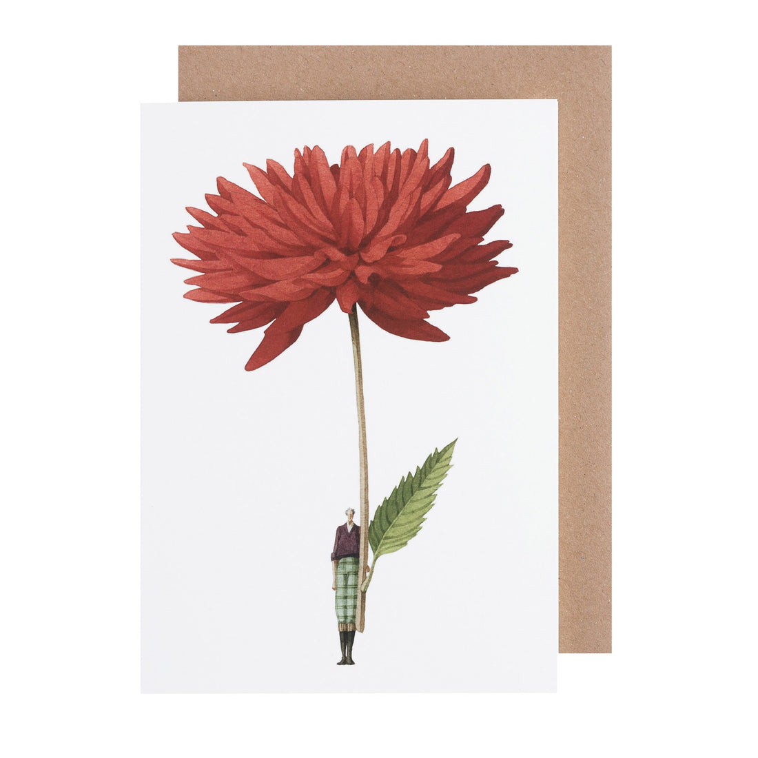 A person holding a large red flower that covers their upper body is depicted on a Hester &amp; Cook Dahlia Greeting Card, made of environmentally sustainable paper, with a brown envelope in the background.