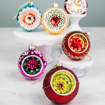 Six vintage inspired Reflector Ornaments displayed on a table.