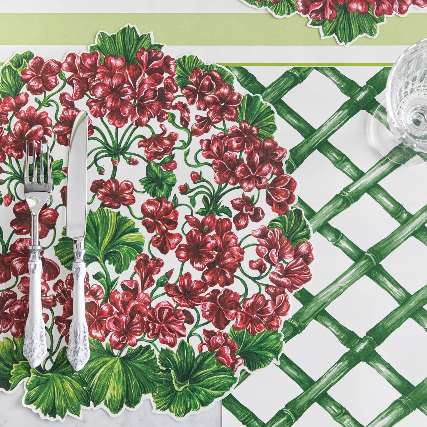 A Green Lattice Placemat with geraniums in a garden setting by Hester &amp; Cook.