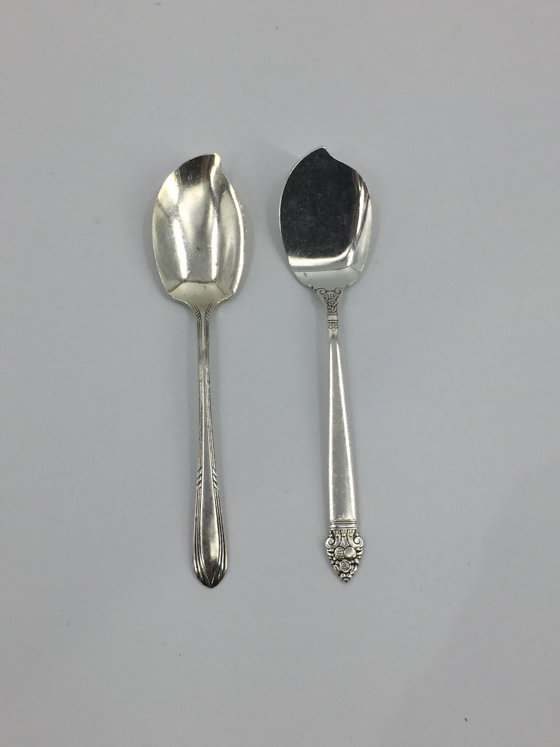 Two Hester &amp; Cook Jam Spreader Silver open stock on a white surface.
