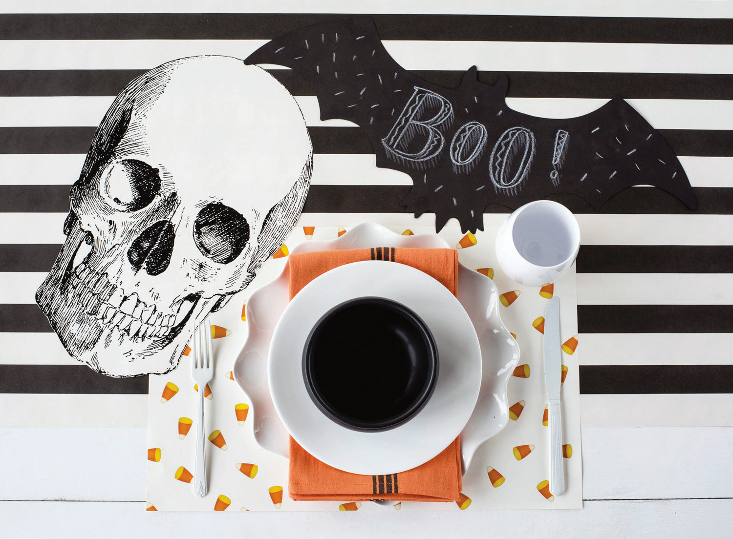 The Black Classic Stripe Runner under a spooky Halloween-themed place setting, from above.