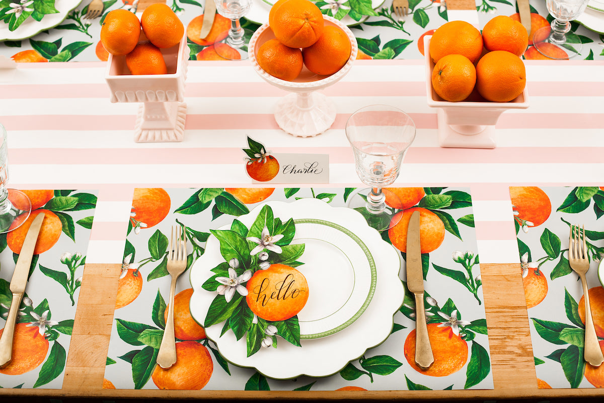 The Orange Orchard Placemat used under an elegant citrus-themed table setting for six.