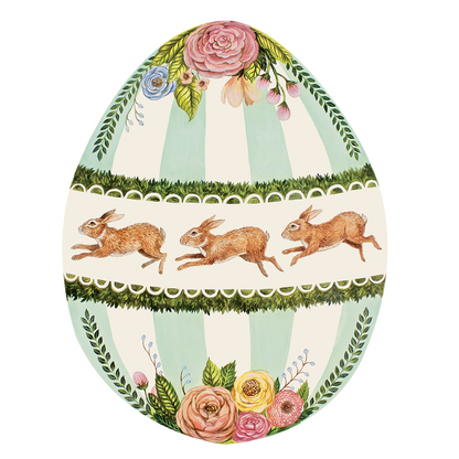 An Easter egg decorated with rabbits and flowers, showcased elegantly on a Die-Cut Boxwood Bunny Egg placemat. The intricate design, created by a talented Nashville artist, adds a touch of charm and whimsy.