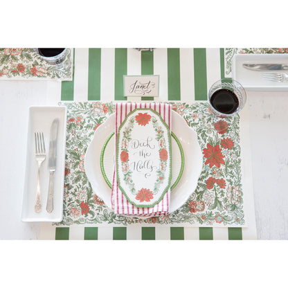 A Christmas place setting featuring a Christmas China Table Accent with &quot;Deck the Halls&quot; written on it in beautiful script.