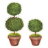 Two Die-cut Topiary Pair Placemats on a table with placemats on a white background. (Brand: Hester & Cook)