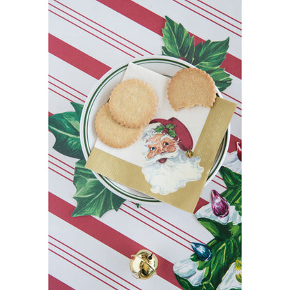 A plate of cookies with Santa Napkins by Hester &amp; Cook on it, perfect for spreading holiday cheer during a table setting.