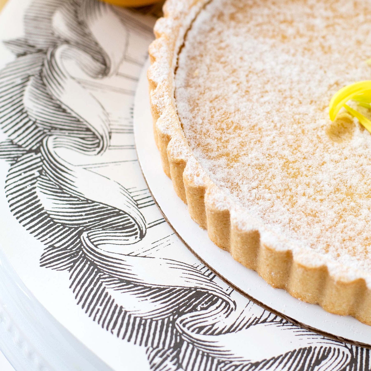 A Rosette Serving Papers lemon tart on a plate by Hester &amp; Cook.