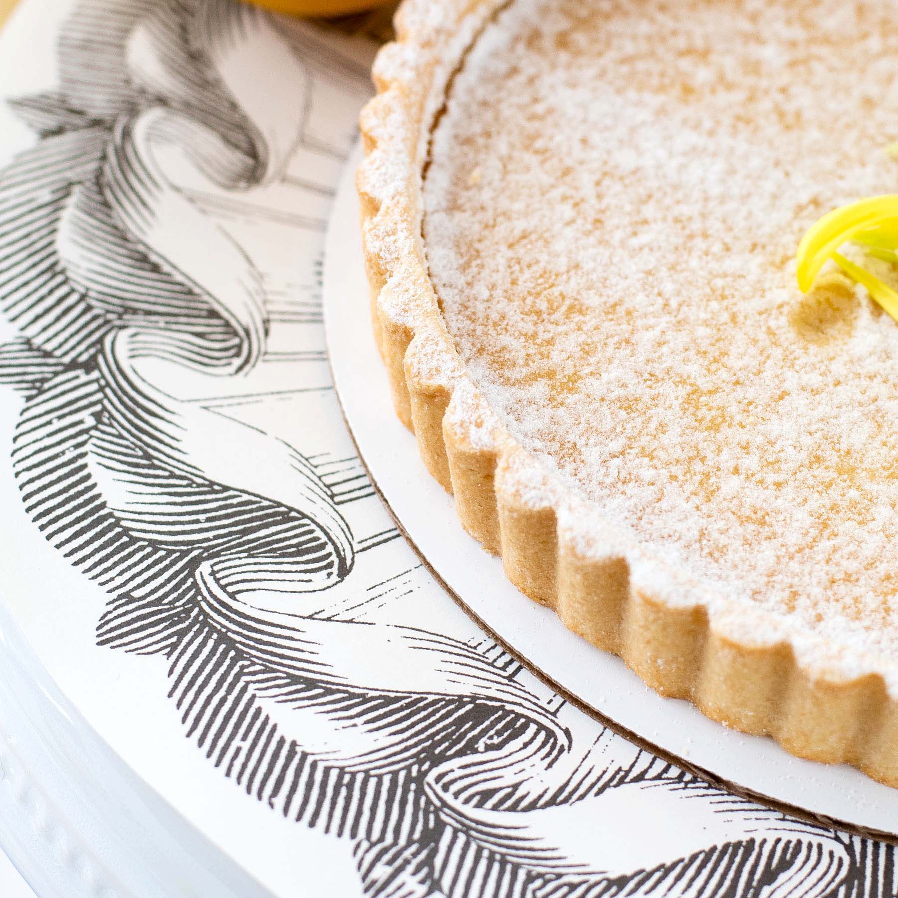 A Rosette Serving Papers lemon tart on a plate by Hester &amp; Cook.