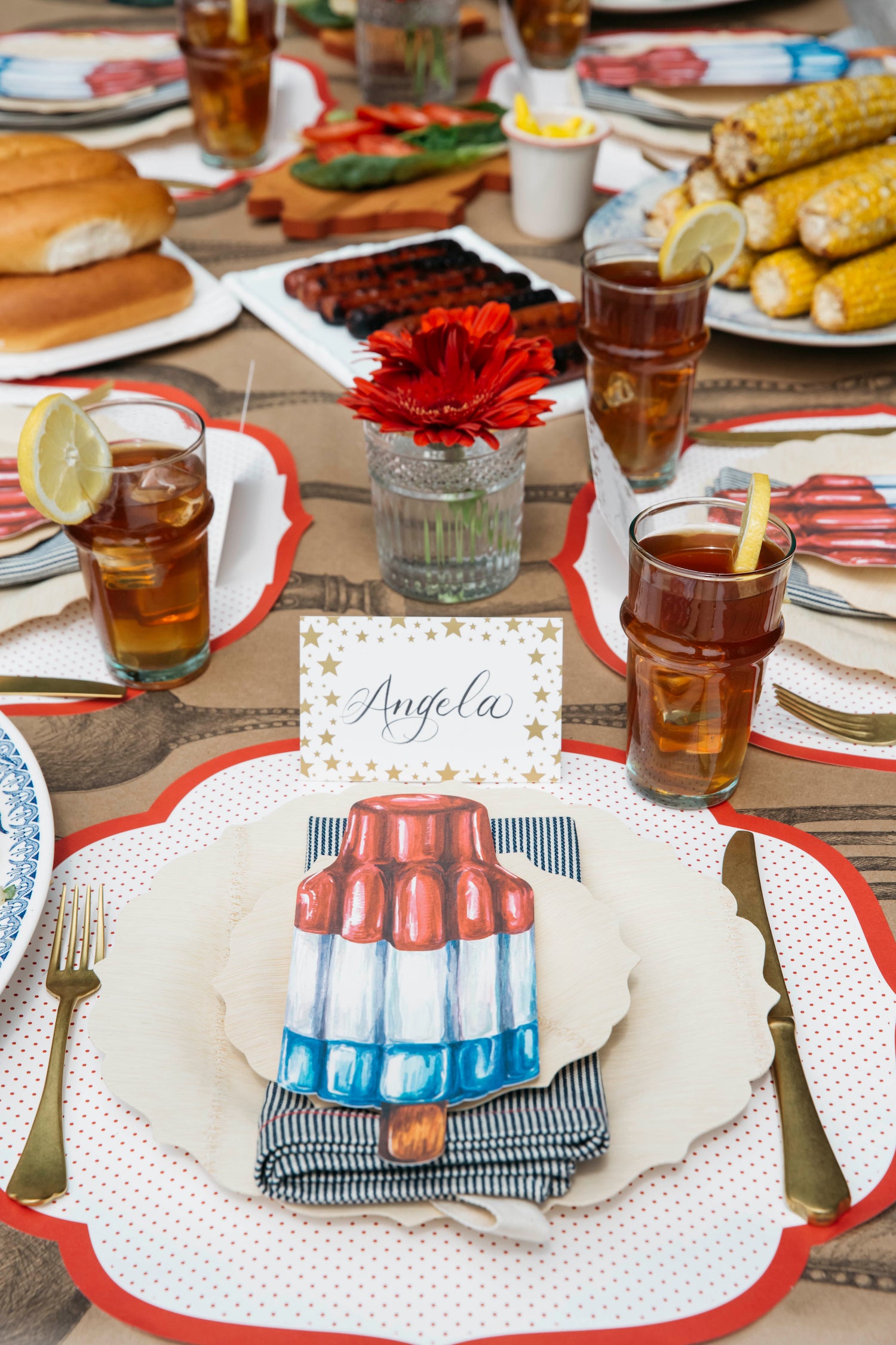 A tablescape for a 4th of July party adorned with Hester &amp; Cook Die-cut Red Swiss Dot paper placemats.