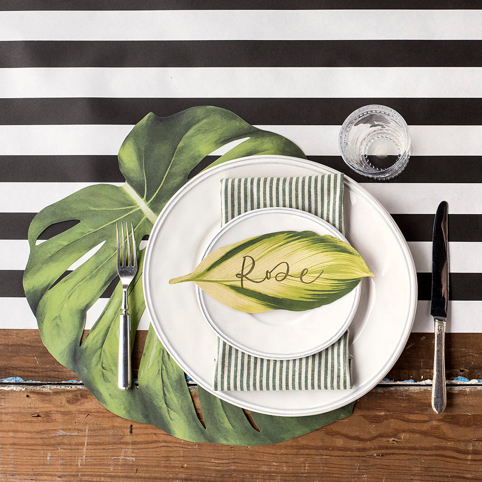 The Black Classic Stripe Runner under an elegant tropical-themed place setting, from above.