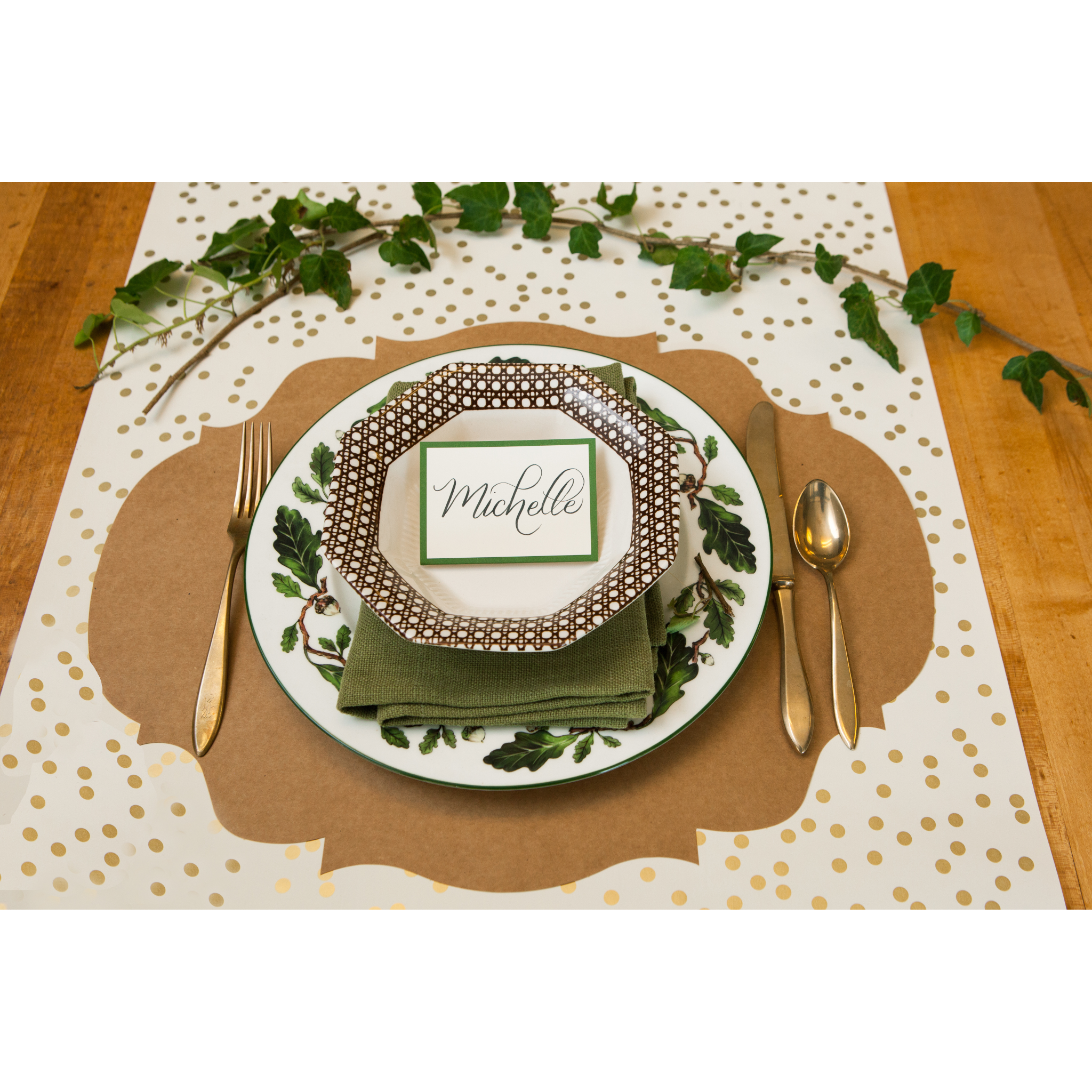 A Hester &amp; Cook Dark Green Frame Place Card with a plate, silverware and napkin for guests at a buffet.