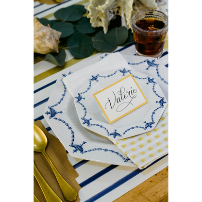 A table setting with a blue and white striped tablecloth and Hester &amp; Cook&