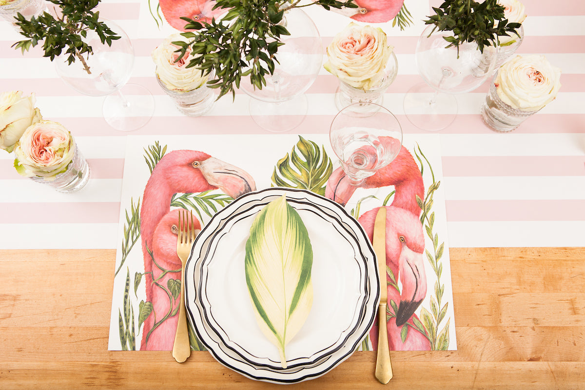 The Pink Classic Stripe Runner under an elegant tropical-themed table setting with flamongos, from above.