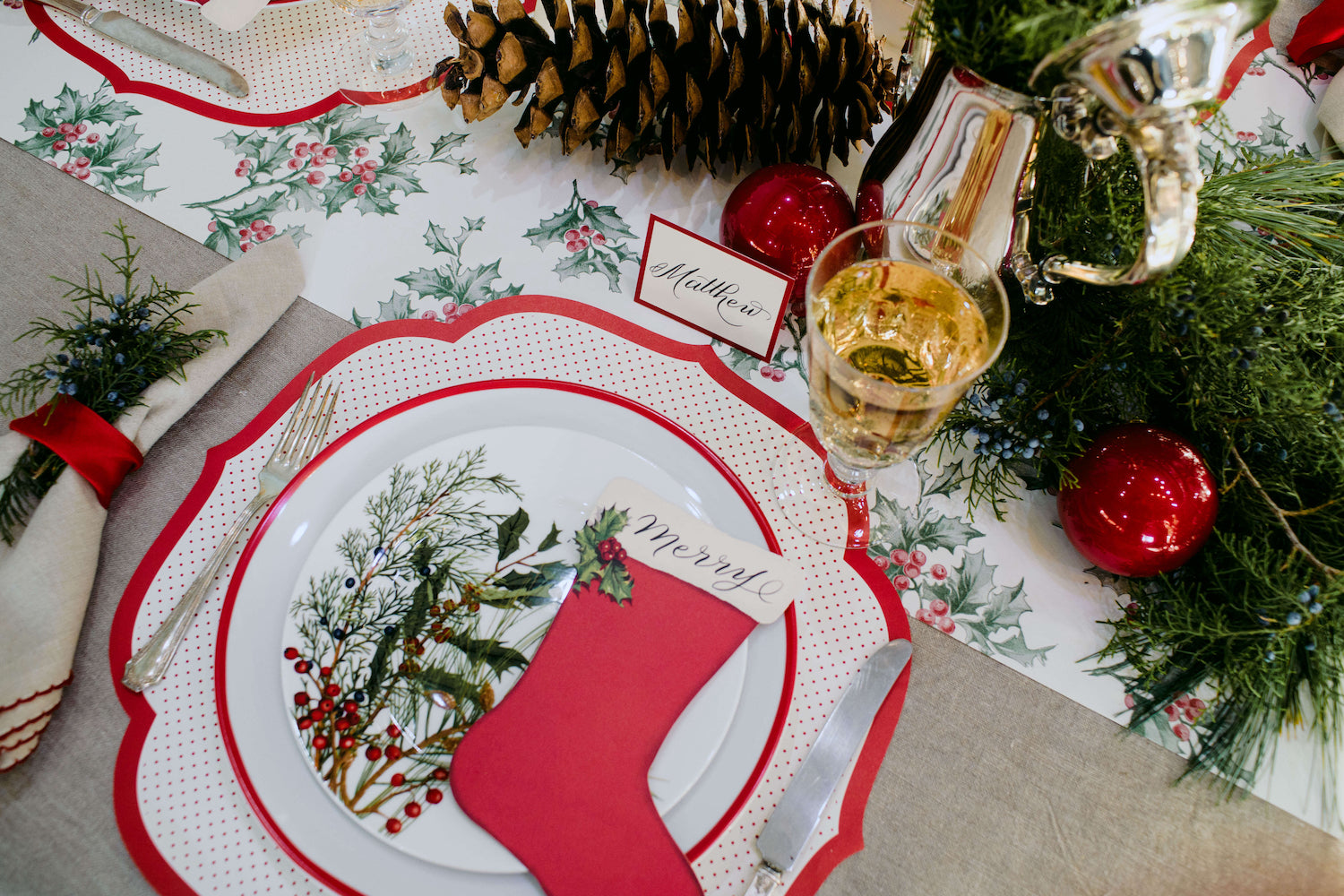 A Christmas tablescape in the USA adorned with red and white decorations, including Hester &amp; Cook&
