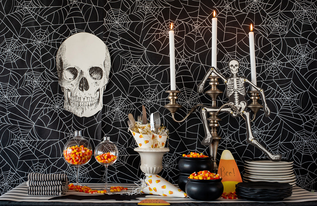 The Spiderweb Runner used as wallpaper behind a spooky Halloween treat table.