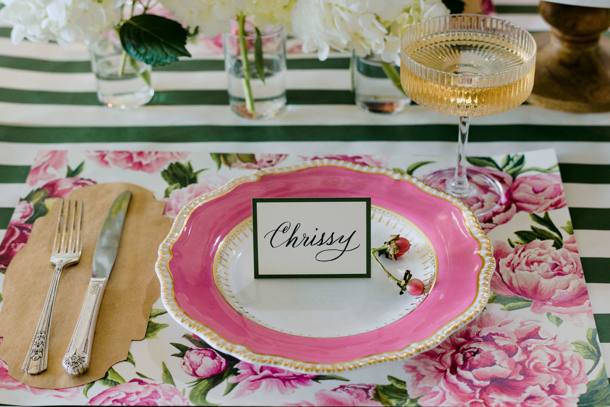An elegant floral place setting featuring a Kraft Frame Table Accent under the cutlery to the left of the plate.