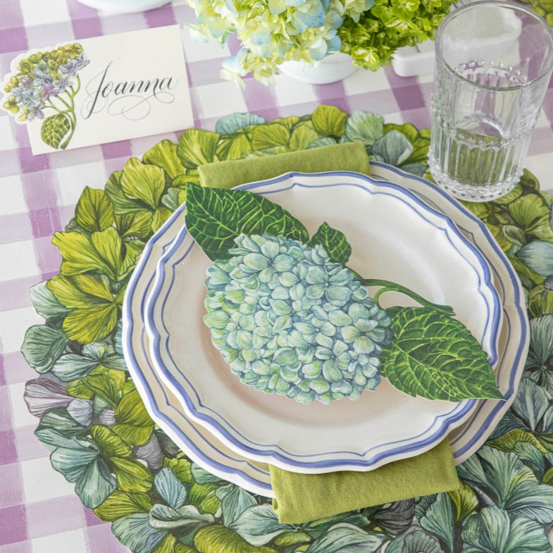 A versatile Hydrangea Table Accent by Hester &amp; Cook featuring hydrangeas on a green and white checkered tablecloth.