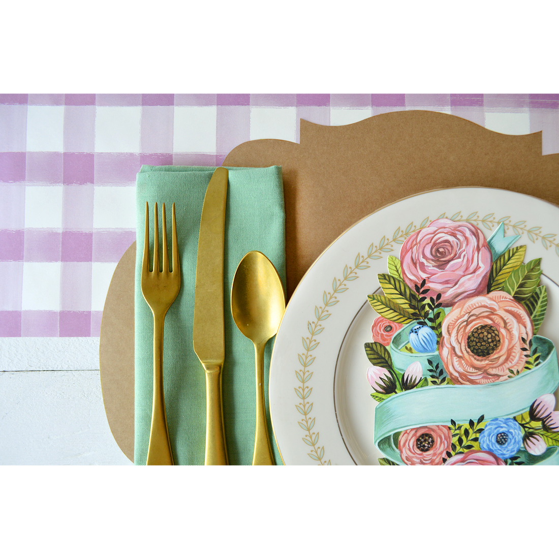 A place setting with a Spring Floral Table Accent plate, fork, and napkin adorned with Hester &amp; Cook spring florals.