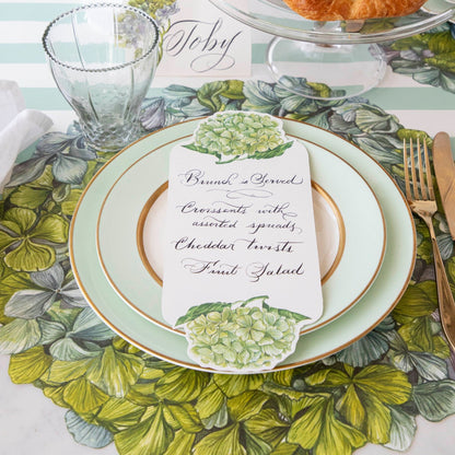 An antique coloring plate adorned with a Hester &amp; Cook Die-cut Hydrangea Placemat.