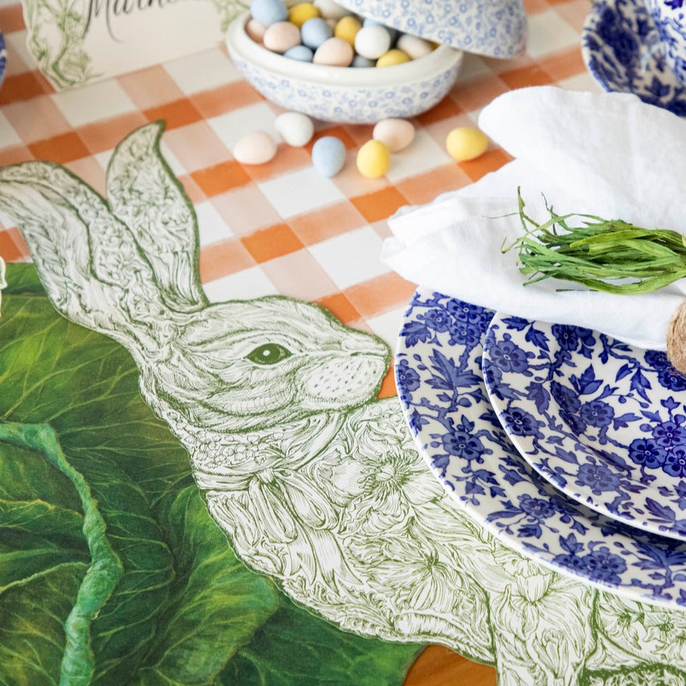 Close-up of the Die-cut Greenhouse Hare Placemat under an elegant Easter place setting.