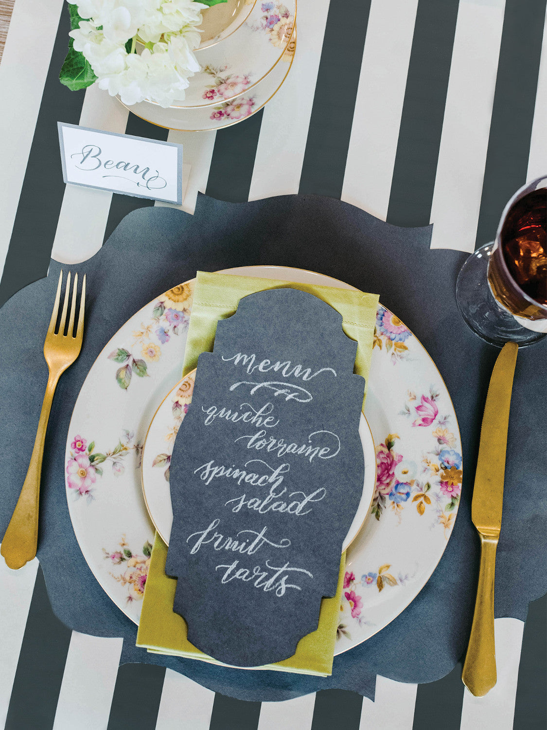 The Gray Classic Stripe Runner under an elegant place setting, from above.