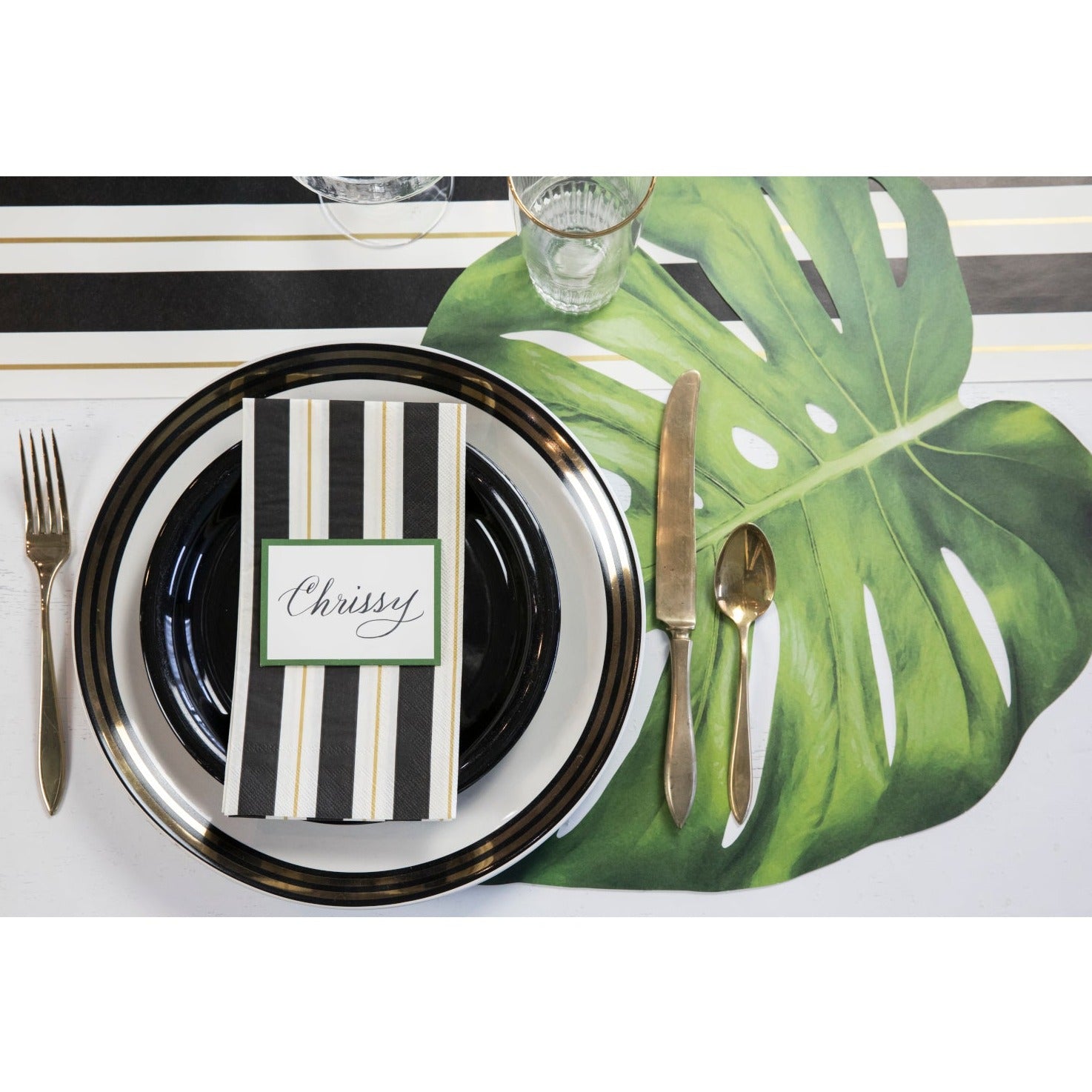 An elegant table setting featuring a Die-cut Monstera Placemat from Hester &amp; Cook as a stylish touch.