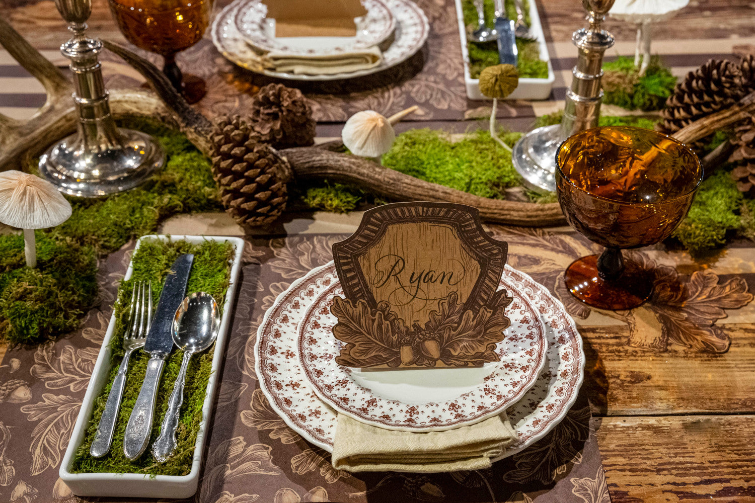 A Hester &amp; Cook Oak Crest place card with leaves and acorns on it, perfect for a Thanksgiving setting.
