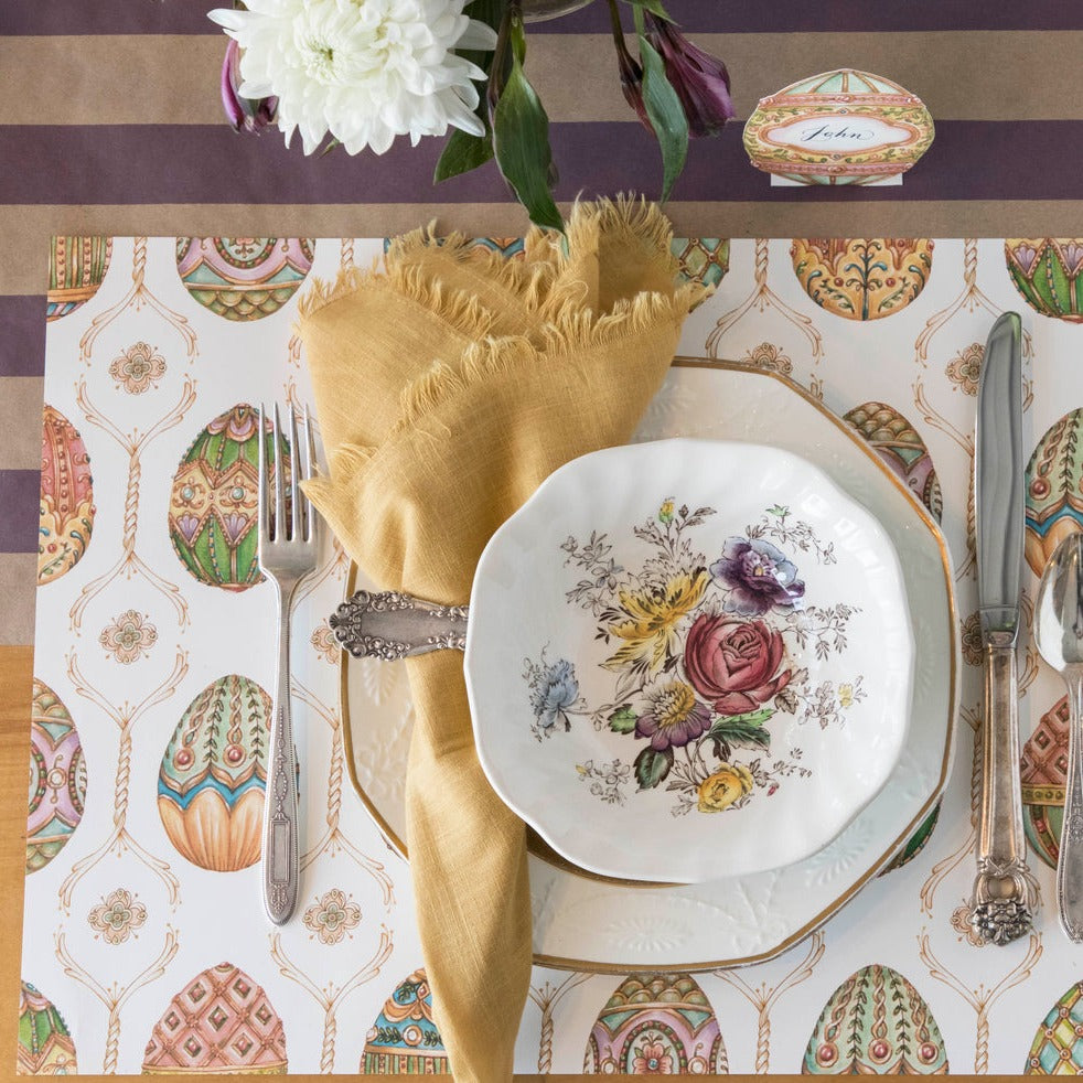 The Exquisite Egg Hunt Placemat under an elegant spring place setting, from above.