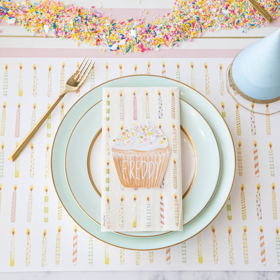A Birthday Candles Placemat with a napkin and a fork on it, perfect for a birthday party made by Hester &amp; Cook.