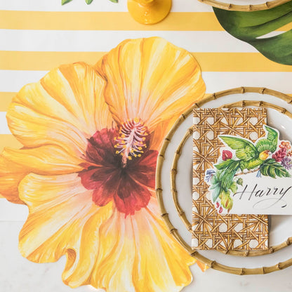 The Die-cut Hibiscus Placemat under a tropical-themed table setting, from above.