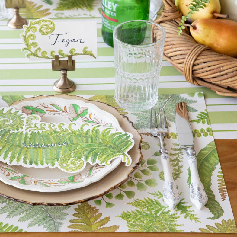 The Fern Collection Placemat under an elegant greenhouse-themed place setting.