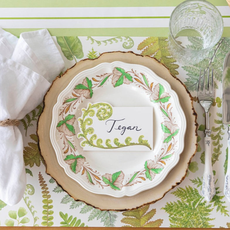 The Fern Collection Placemat under an elegant greenhouse-themed place setting, from above.