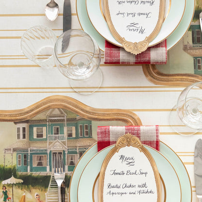 An elegant table setting with a place setting and a Hester &amp; Cook Antique Gold Stripe Runner.
