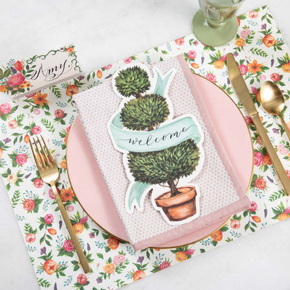 A pink place setting with a Topiary Table Accent from Hester &amp; Cook on it.
