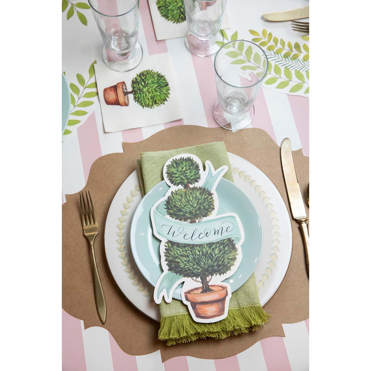 A table setting with a potted plant on it, adorned with a Hester &amp; Cook Topiary Table Accent.