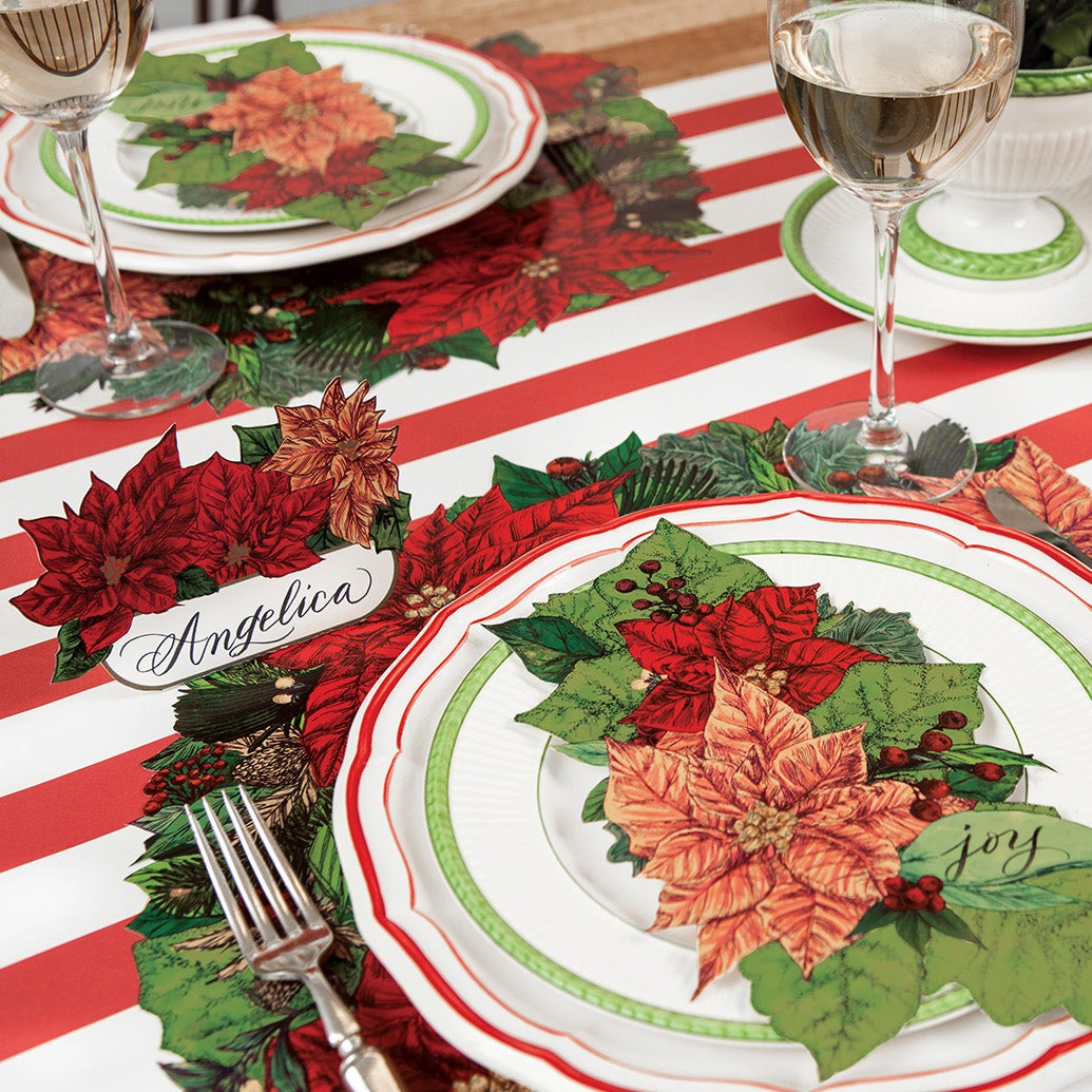 A festive holiday table setting featuring Poinsettia Place Cards in front of each place setting.