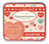A tin box with Vintage Valentine Stickers featuring various love-themed designs, such as hearts and phrases like &