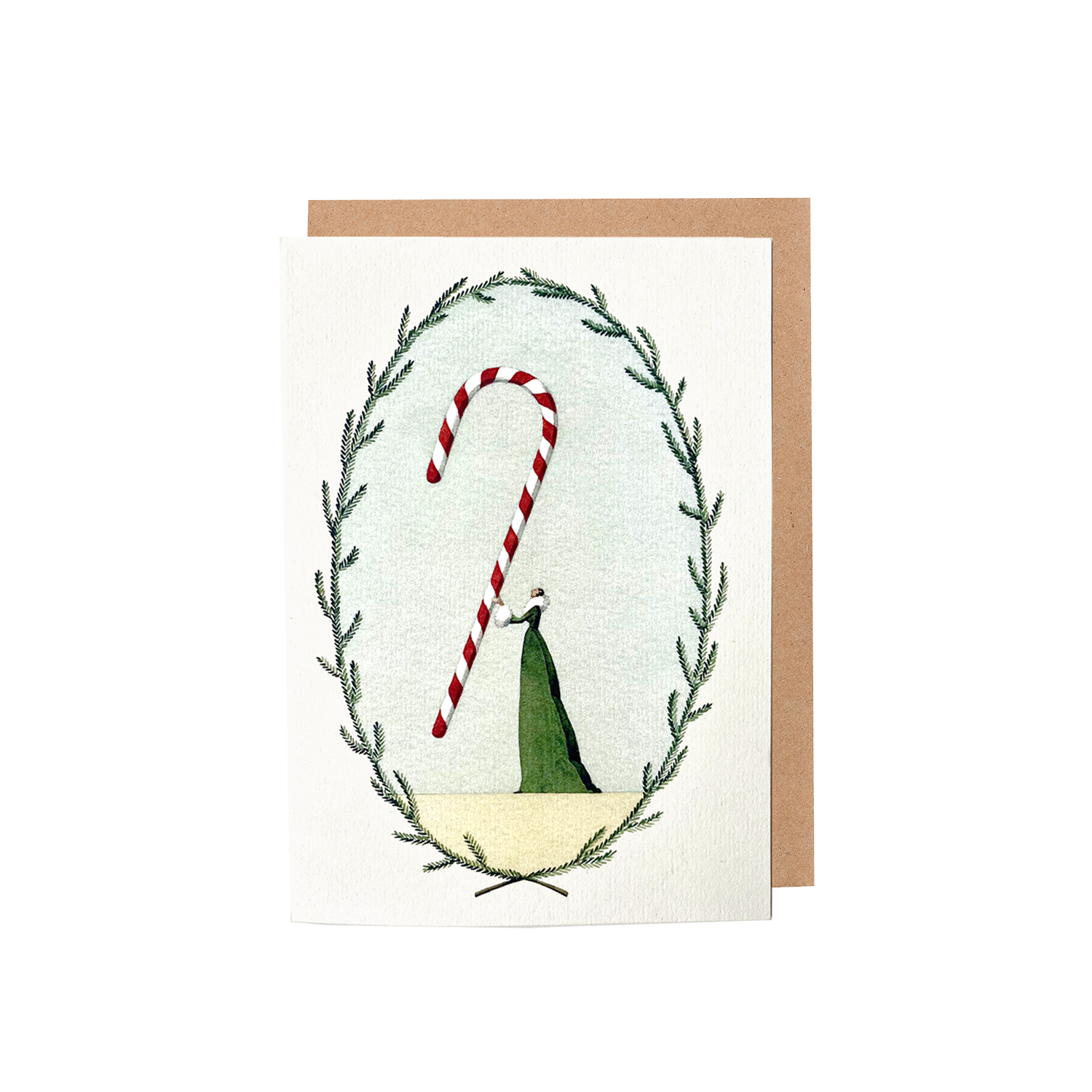 The Candy Cane Greeting Card features an illustration of a woman in a long green dress holding a gigantic red and white candy cane within a frame of green foliage, with a brown kraft paper envelope included.