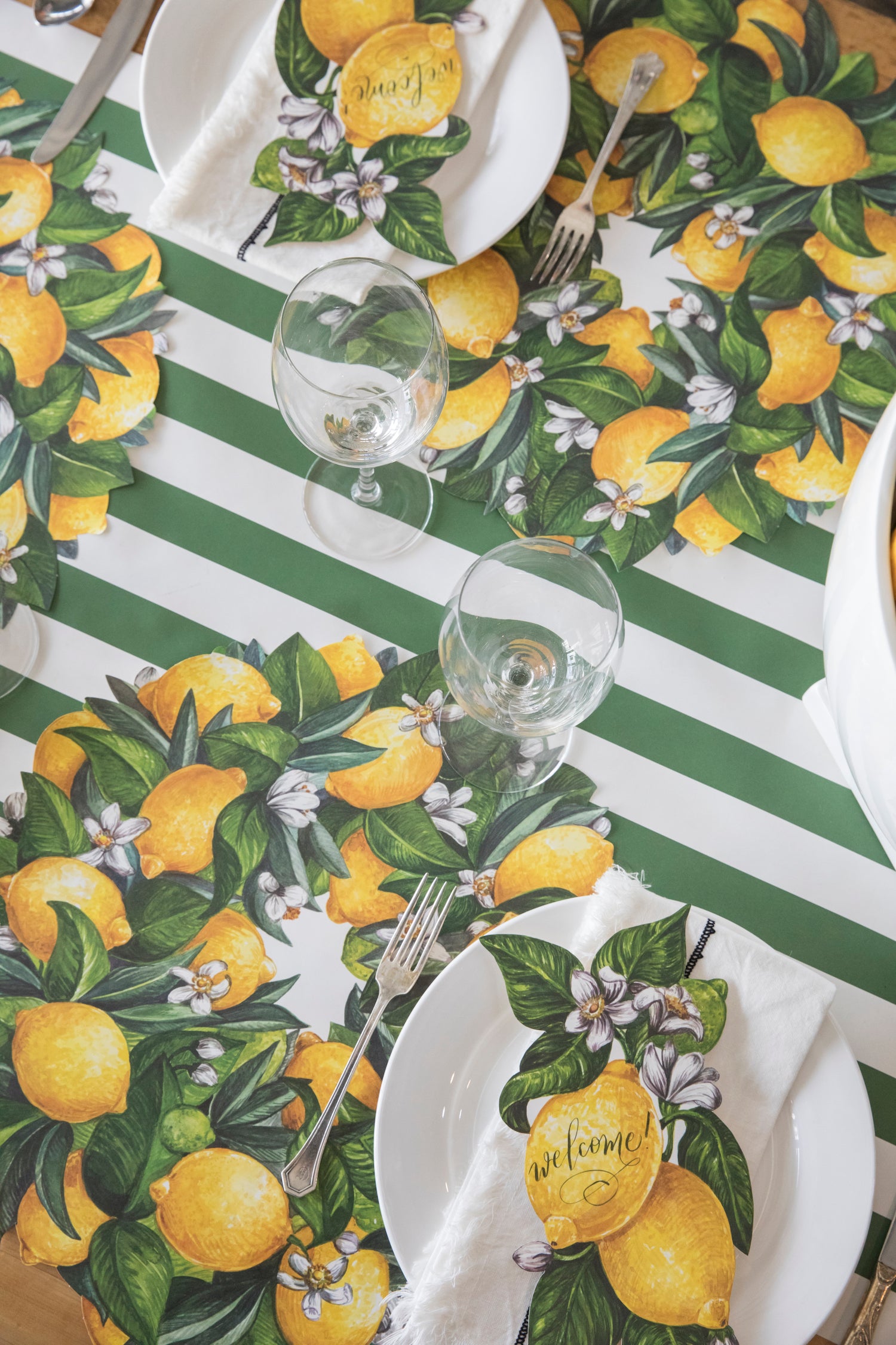 A table setting with Die-cut Lemon Wreath Placemats from Hester &amp; Cook.