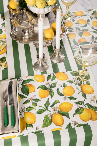 A table setting with Lemon Placemats from Hester &amp; Cook on a green and white kitchen table.