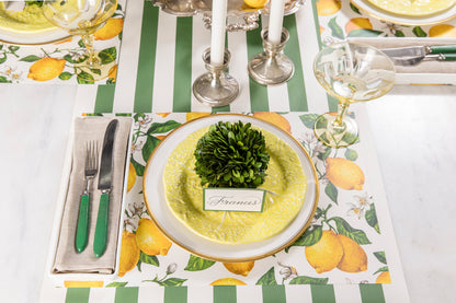 A kitchen table setting with lemons on a Hester &amp; Cook Lemon Placemat.