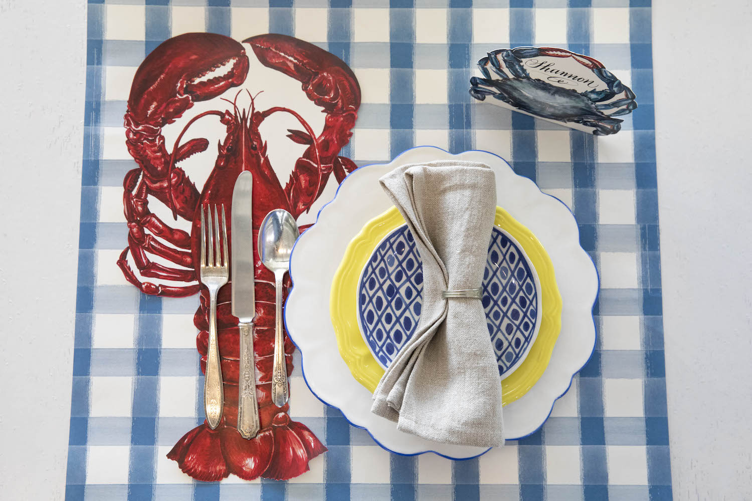 The Die-cut Lobster Placemat under the cutlery in an elegant place setting, from above.